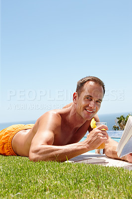 Buy stock photo Man, book and reading on grass in portrait by ocean with knowledge, relax and swimming pool on vacation. Person, cocktail and novel on lawn with pride, topless or outdoor for holiday by sea in Naples