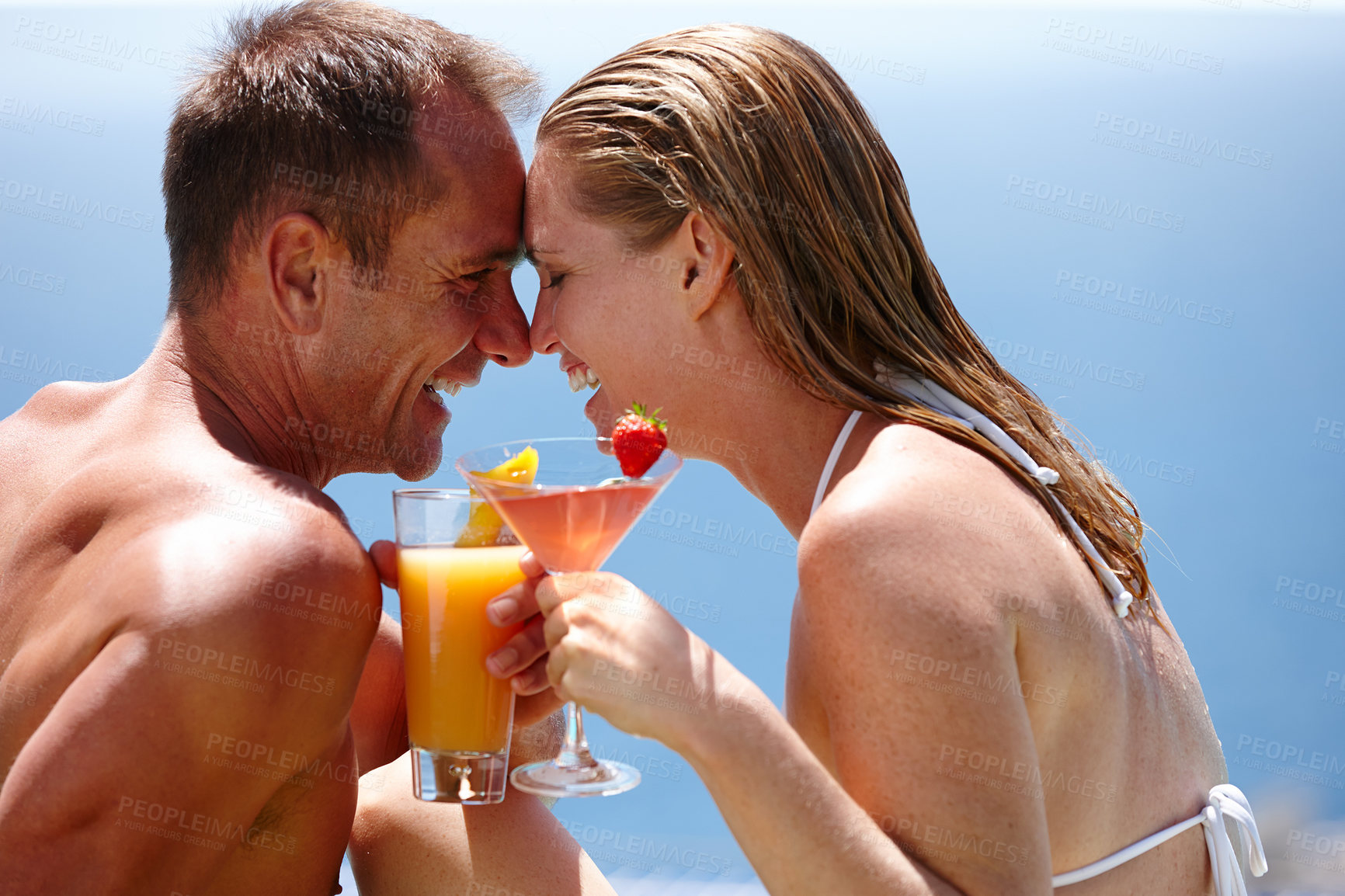 Buy stock photo Couple, happy and toast with cocktail by swimming pool with care, vacation and love in summer. Man, woman and smile by ocean with drink, alcohol or outdoor in sunshine, water and holiday in Naples