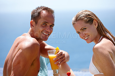 Buy stock photo Couple, portrait and relax with cocktail by swimming pool with care, vacation and love in summer. Man, woman and smile together with drink, alcohol or outdoor in sunshine, water and holiday in Naples