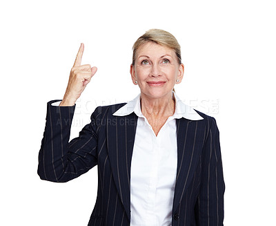 Buy stock photo Senior business woman, smile and pointing finger up in white background for suggestions, product placement and mockup. Elderly person, happy face and corporate manager hand gesture isolated in studio