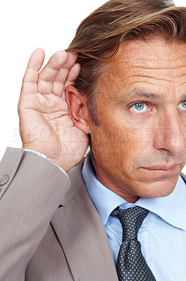 Buy stock photo Hear, secret and businessman holding his ear in a studio while listening to a whisper conversation. Communication, listen and corporate male model hearing a discussion isolated by a white background.