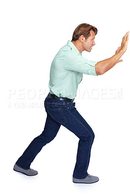 Buy stock photo Man, pushing and obstacle or frame in struggle against a white studio background. Isolated casual male walking to push heavy weight or shield using physical effort with expression or gesture