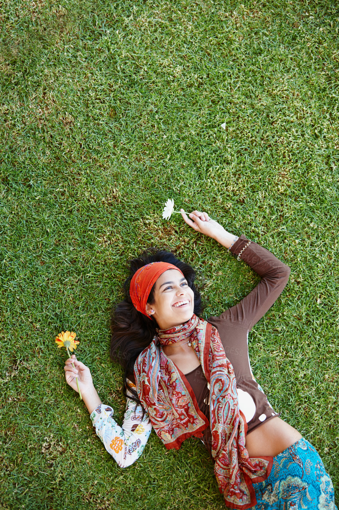 Buy stock photo Outdoor, bohemian and woman in nature, smile and clothes with aesthetic of fashion and above. Peace, female person and girl with flower in field, summer and relax on grass with outfit for art