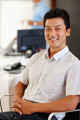 Buy stock photo Portrait, man and happy in creative office, web designer sitting in chair in workplace. Smile, professional and Asian male person in business, confident and comfortable relaxing Japanese staff