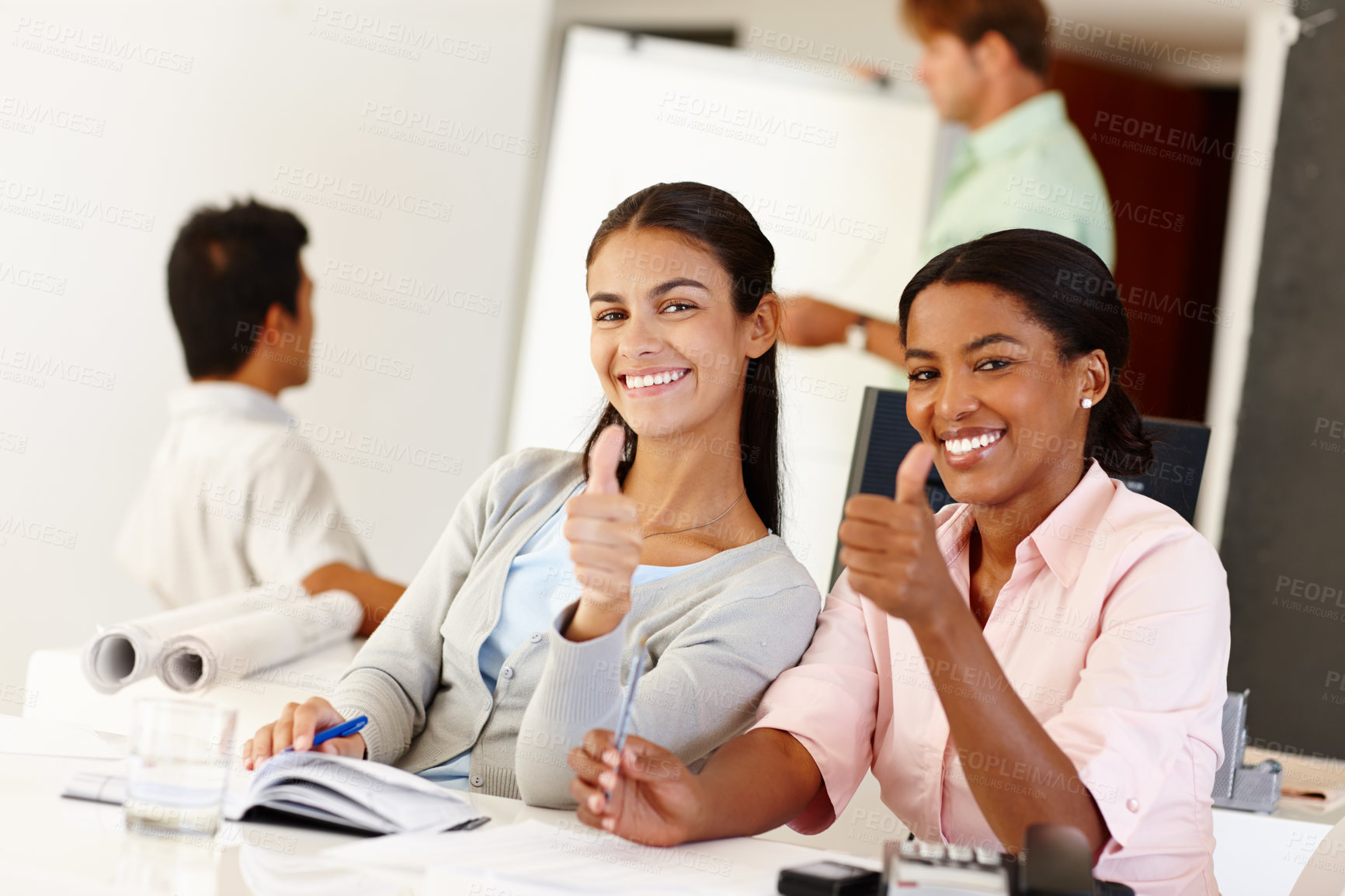 Buy stock photo Happy, businesswomen and success with thumbs up or thank you for startup, collaboration and teamwork. Diverse corporate workers and smile with hand sign for goal, triumph or achievement at office
