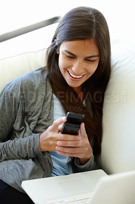 Buy stock photo Laptop, funny and laughing woman, smartphone and couch at home for relax. Joke, comic and texting on cellphone or technology for social female person, mobile networking or freelance work on sofa