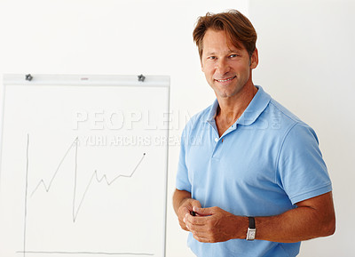 Buy stock photo Medium shot of a mature man standing beside a whiteboard