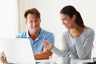 Buy stock photo Shot of two people using a laptop in a relaxed meeting