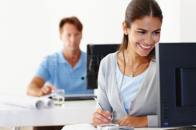 Buy stock photo Computer, smile and business woman writing notes, information or research on internet in creative startup. Desktop, professional and happy designer with book, reading or architect planning at table