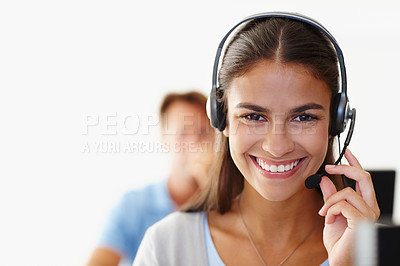 Buy stock photo Portrait of happy female call center telemarketing agent smiling while talking on headset while working in office. Confident friendly consultant operating helpdesk for customer service and support