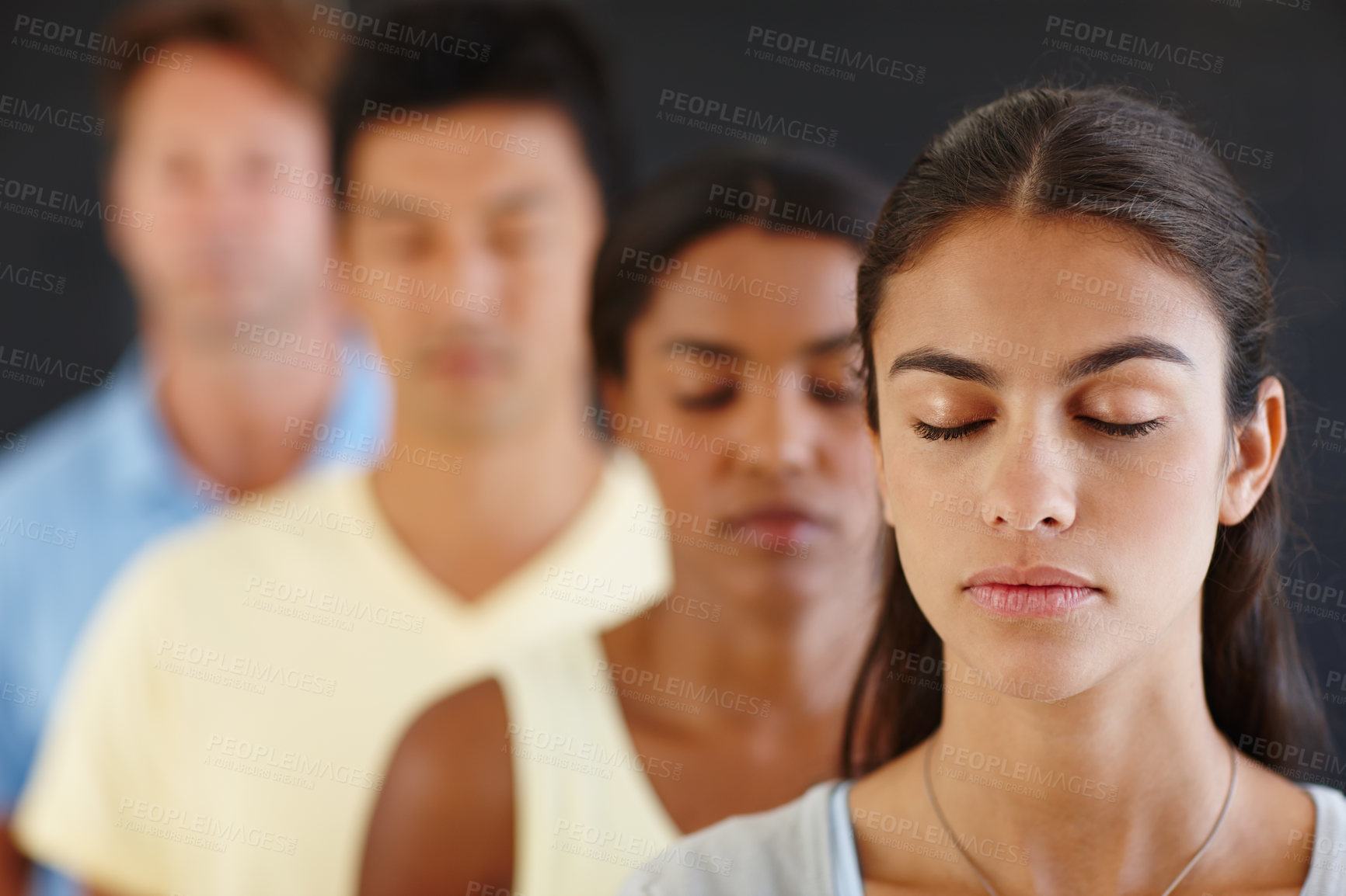 Buy stock photo Diversity, people and row with eyes closed for meditate in dark background for peace, calm and healthy mind. Group, standing and concentrate for yoga for health or hobby with friendship and wellness