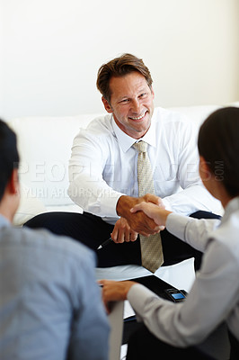 Buy stock photo Smile, handshake and businessman in meeting, partnership and promotion or agreement with client. Happy, corporate and interview with shaking hands, male entrepreneur and business collaboration