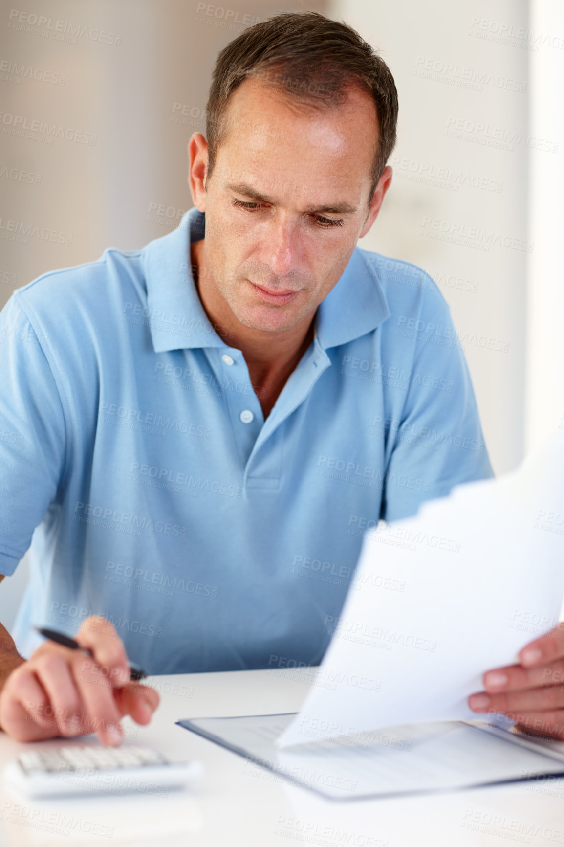 Buy stock photo Shot of a businessman doing work at a desk