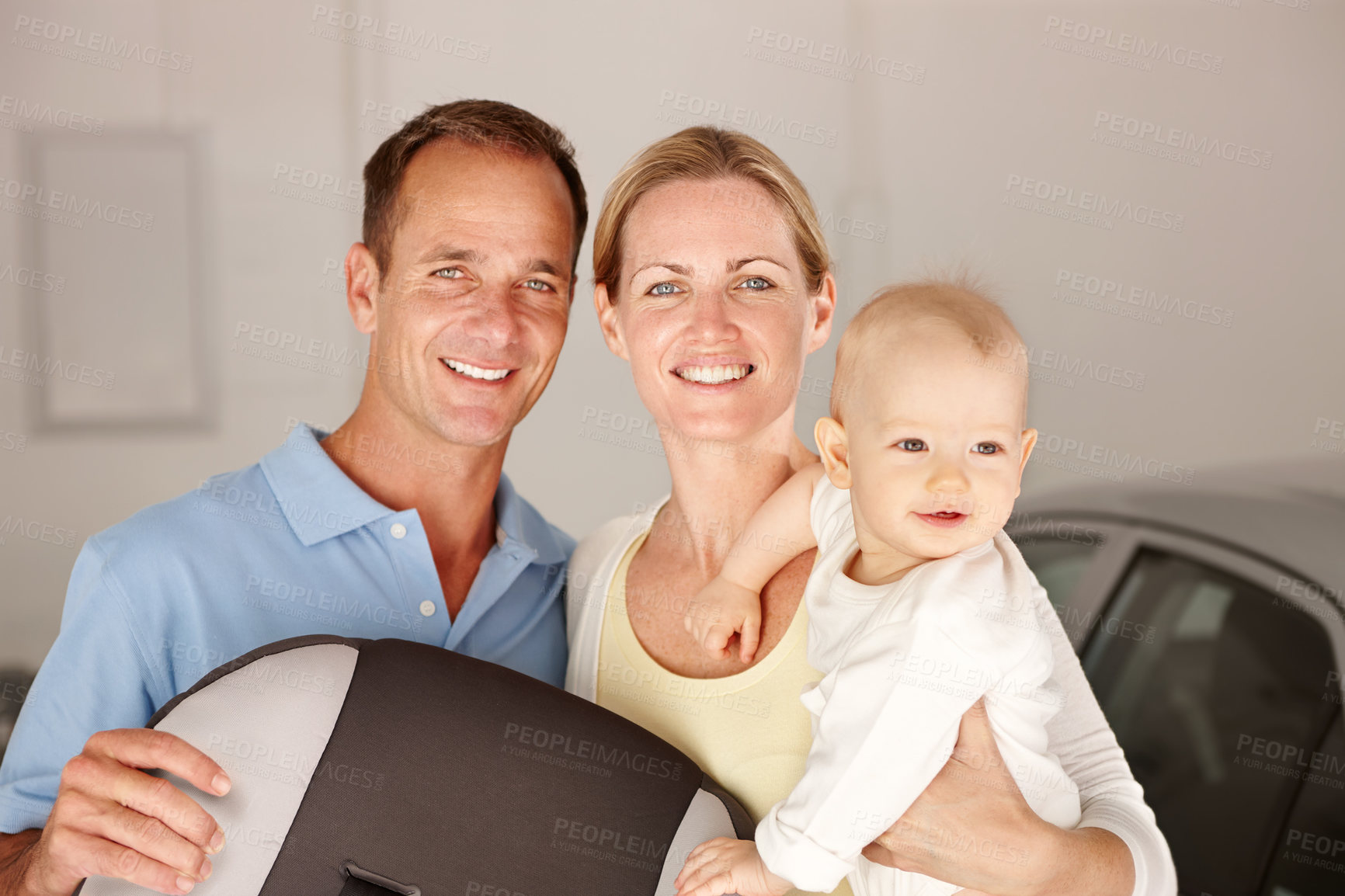 Buy stock photo Couple, child and portrait with home, family love and smile or happiness for domestic. Father, mother and kid in house, garage and car for travel with parenting relationship and childhood bonding