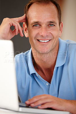 Buy stock photo Portrait of a mature man using a laptop indoors