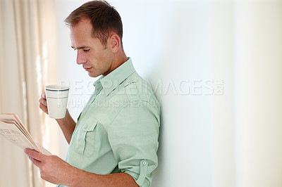 Buy stock photo Man, newspaper and reading with morning coffee, global news articles and headlines and checking stock information. Happy, smile male person and relax with beverage to drink, lounge in apartment