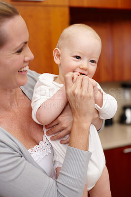 Buy stock photo Happy, mother and baby in kitchen for love, child development and bonding at home, house and apartment together. Woman, kid and family with smile for pride, growth and affection with embrace or hug