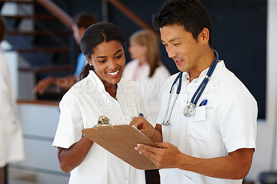 Buy stock photo Shot of two doctors dicussing patient diagnosis