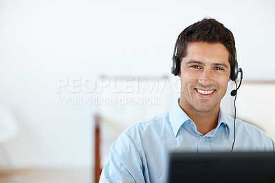 Buy stock photo Cropped shot of a young man wearing a headset in his office