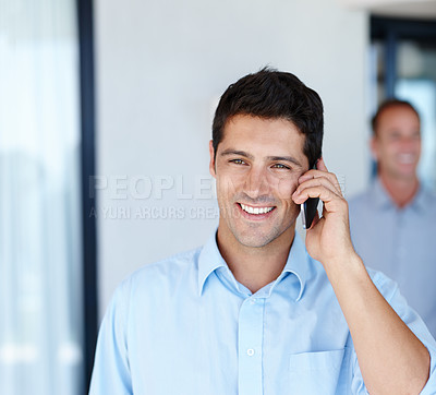 Buy stock photo Head and shoulders shot of a young man using his cellphone