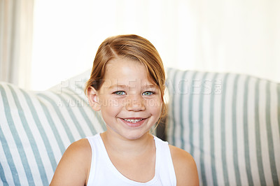Buy stock photo Portrait, smile and girl child in home on sofa alone to relax in living room of apartment. Face, couch and adorable young kid in lounge, casual and positive with happiness in house in Switzerland