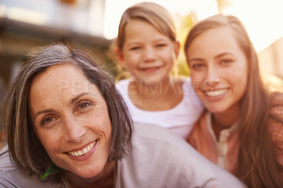 Buy stock photo Happy, generations and portrait of family in outdoor garden for love, bonding or spending quality time together. Smile, relaxing and weekend break with grandmother, daughter or young girl in backyard