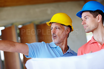 Buy stock photo Cropped shot of an architect and a contractor