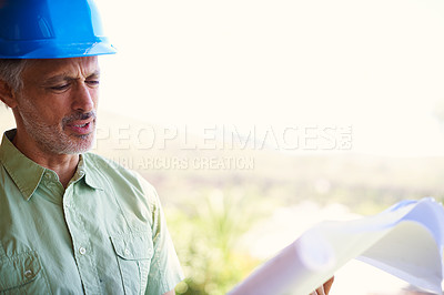 Buy stock photo Shot of a building contractor discussing blueprints