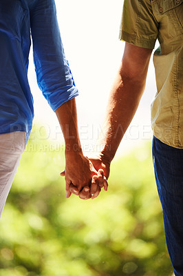 Buy stock photo Couple, holding hands and bonding together in nature for romance and commitment in healthy relationship in outdoor. People, love and marriage with touch for care, trust and walking for break in park