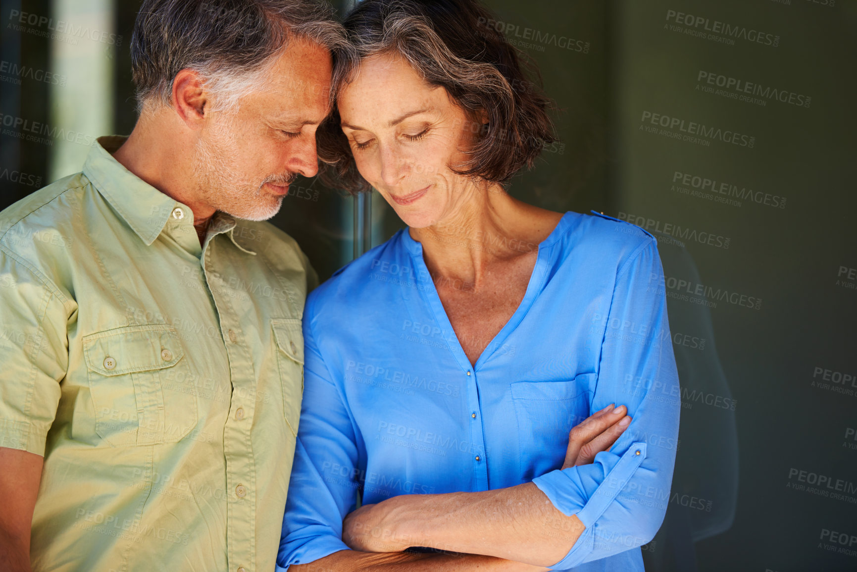 Buy stock photo Shot of a mature couple leaning in toward eachother