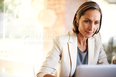 Buy stock photo Shot of a mature businesswoman working at a desk