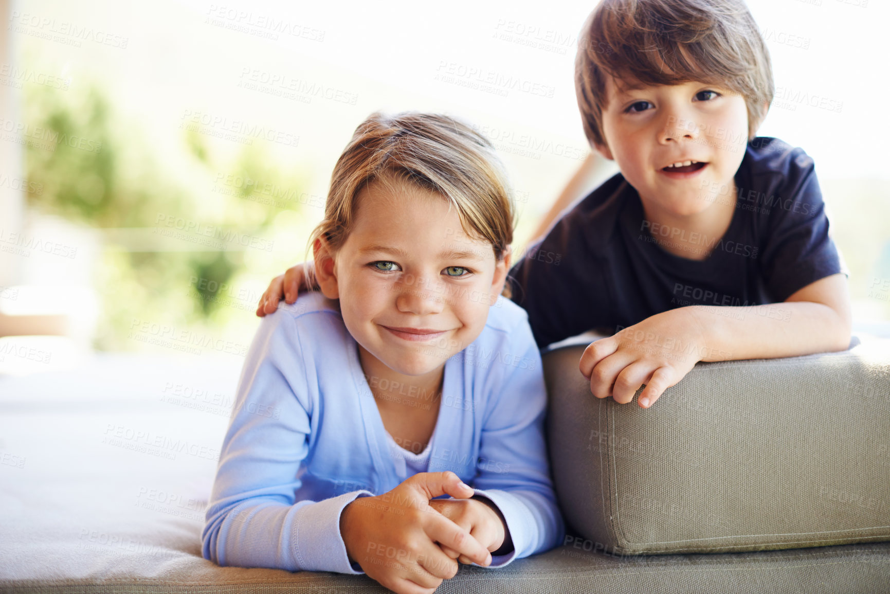 Buy stock photo Children, boy and girl as siblings on sofa in family house relaxing with love, care and bonding in living room. Portrait, happy kids and home for embracing with joy on lounge couch in Australia