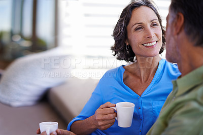Buy stock photo A cropped shot of a happy mid adult couple drinking tea together outdoors