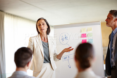 Buy stock photo A cropped shot of a confident mid adult businesswoman making a presentation at work