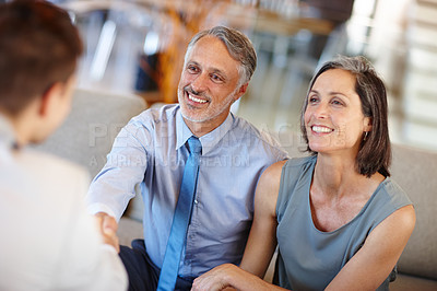 Buy stock photo Meeting, handshake and happy couple for agreement, real estate and buying new property or home. Smile, deal and married wife and man talking with agent, investment for retirement and finance  