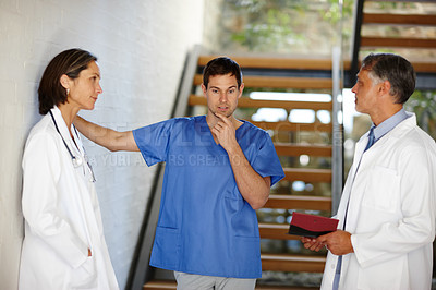 Buy stock photo Medical, team and conversation with thinking people, hospital nurse and doctor in discussion for patient result. Health, collaboration or consulting surgeon for help, healthcare idea or brainstorming