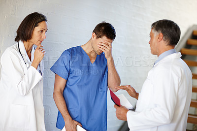 Buy stock photo Medical, team and sad nurse with doctors together, bad result or news and professional support for empathy. Hospital intern, collaboration for comfort or burnout or grief, conversation with surgeon