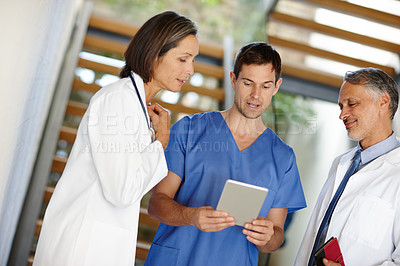 Buy stock photo Medical, team and conversation or working with tablet, hospital nurse with doctor in discussion for patient results. Health, collaboration on tech for research, consulting surgeon on healthcare