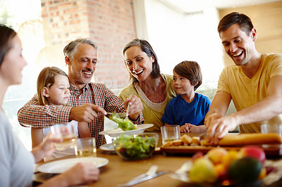 Buy stock photo A cropped shot of a happy multi-generational family eating a meal together at home