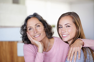 Buy stock photo A mature mother holding her daughter affectionately around the neck