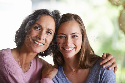 Buy stock photo A mom and daughter smiling happily while sitting indoors