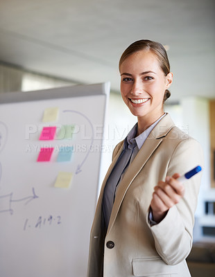 Buy stock photo A young woman gesturing with her hand while standing in her office doing a presentation