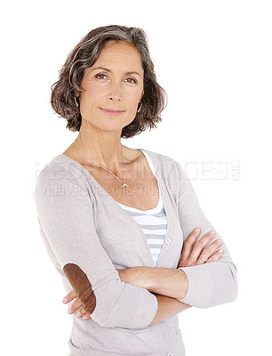 Buy stock photo Portrait of a mature woman standing in a studio with her arms folded