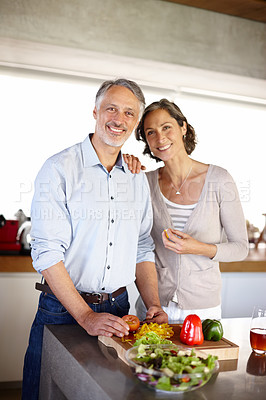 Buy stock photo Mature couple, portrait or cooking in kitchen with support, salad bowl or vegetables for healthy meal. Man, woman and smile at table with preparation for dinner, lunch or nutrition in home with relax