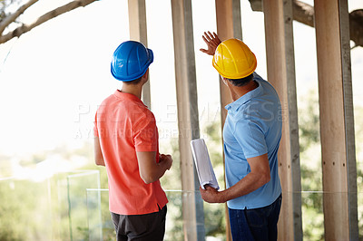 Buy stock photo Building, construction and architect with man on site for inspection, project management and planning. Professional contractor, engineer or developer with blueprint, pointing and design from back