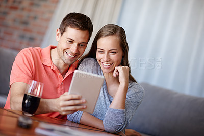 Buy stock photo Couple, relax and happy in home with tablet for streaming online for movies or films, videos and social media memes. Man, woman and together with love for bonding or embrace with care and support