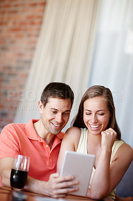 Buy stock photo Couple, relax and smile in home with tablet for streaming online for movies or films, videos and social media memes. Man, woman and together with hug for bonding or love with affection and support.