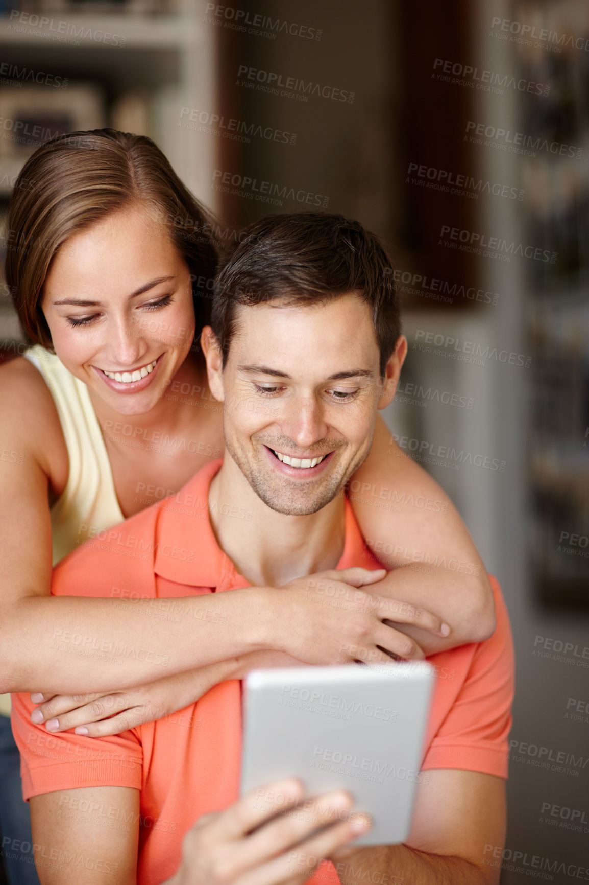 Buy stock photo Couple, hug and happy in home with tablet for streaming online for movies or films, videos and social media memes. Man, woman and together with hug for bonding or love with affection and support