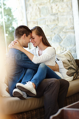 Buy stock photo Home, couple and forehead for love, embrace and romance or care on couch in living room. Happy people, touch and smile for pride in relationship or commitment, loyalty and connection on hug date