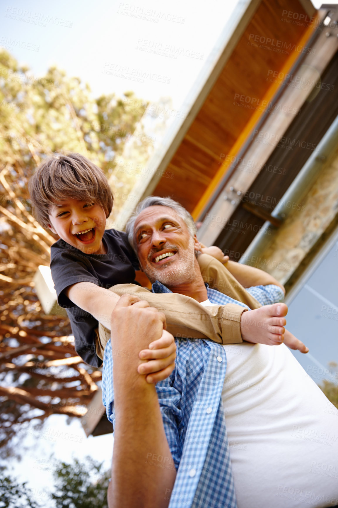 Buy stock photo Grandfather, playing and happy child on grass at family house with embrace, bonding and love with care in garden.
Grandpa, people and kid on shoulders in outdoors on vacation with nature for memory
